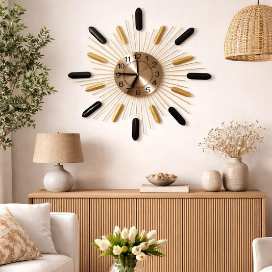Close-up of sunburst wall clock dial with brushed metal face and black brass rays
