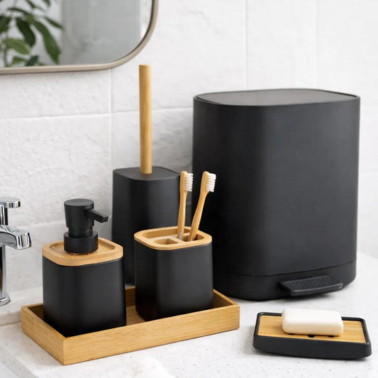 Modern matte black bathroom accessories with natural bamboo accents for a spa-style countertop