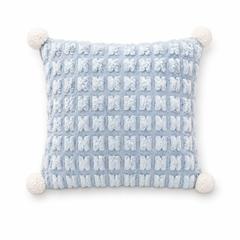 A Chic Pillow That Unfolds Into a Throw-Textured Grid + Pom-Poms for Instant Style