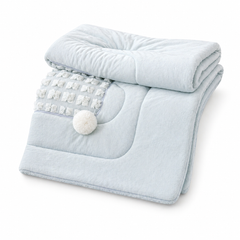 A Chic Pillow That Unfolds Into a Throw-Textured Grid + Pom-Poms for Instant Style