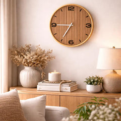 Close-up of gold rim and woodgrain MDF clock face with bold numerals and contrasting hands